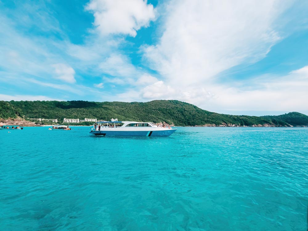 Boats anchored next to tropical island